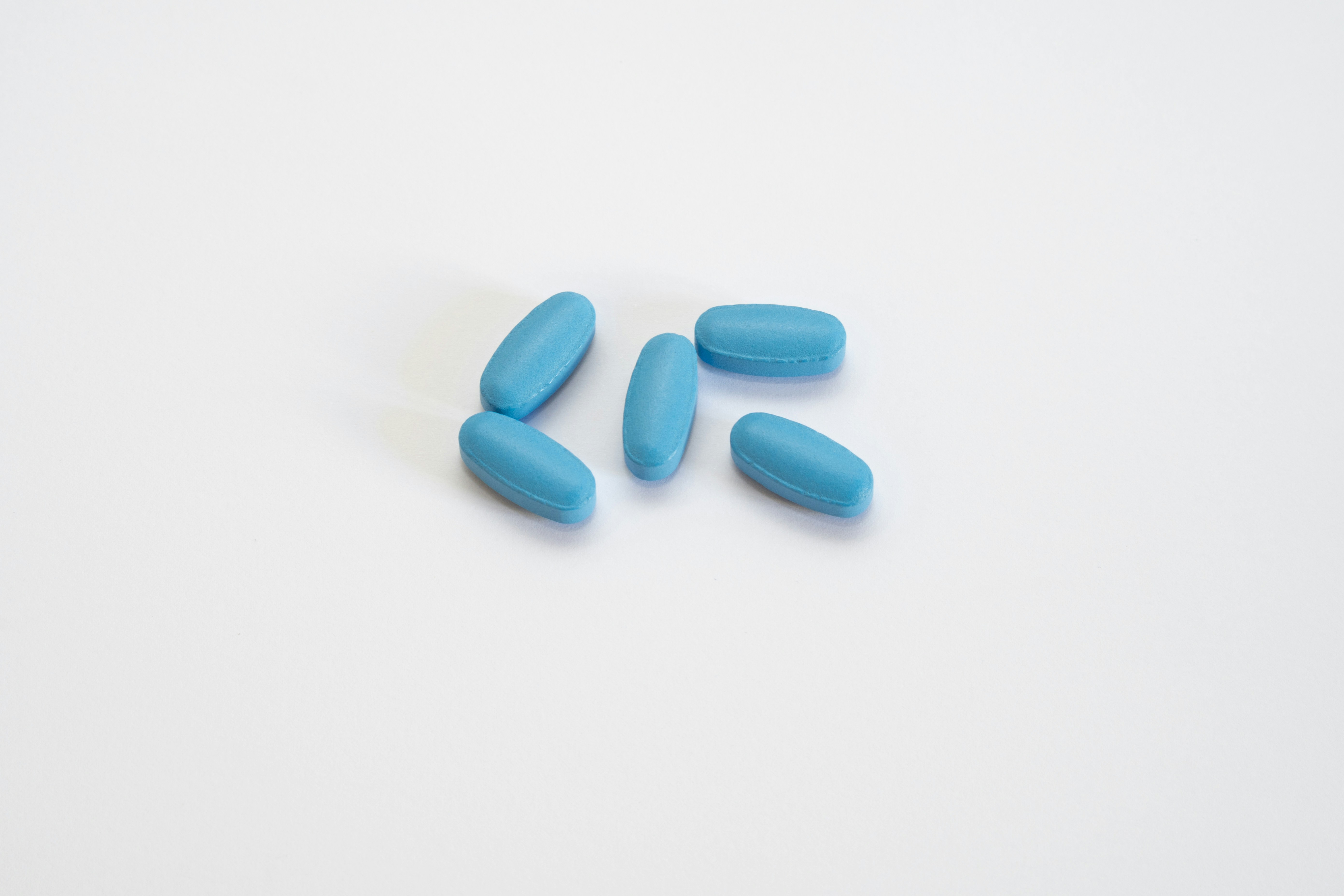 Five pills on a white background